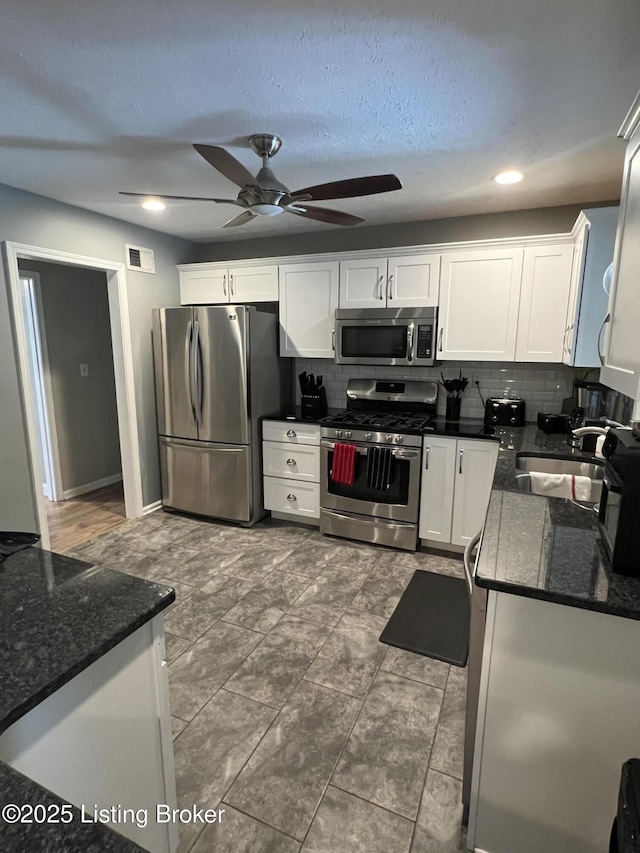12112 Alpine Way, Goshen, KY 40026 - kitchen with appliances with stainless steel finishes, a ceiling fan, tasteful backsplash, white cabinets, and recessed lighting