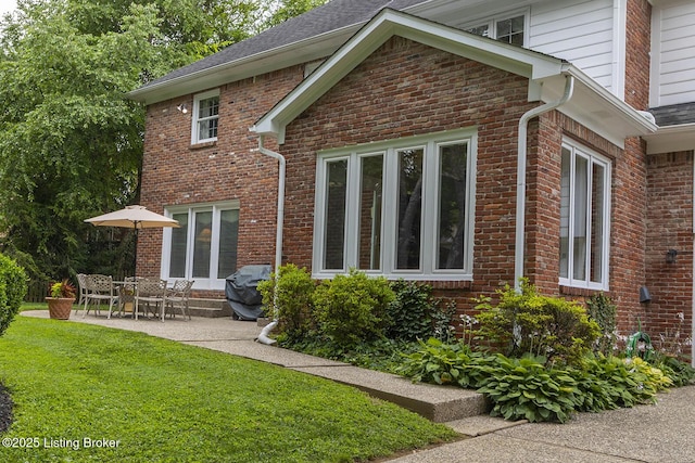 7005 New Bern Ct, Prospect, KY 40059 - back of property with a lawn, brick siding, a patio area, and a shingled roof