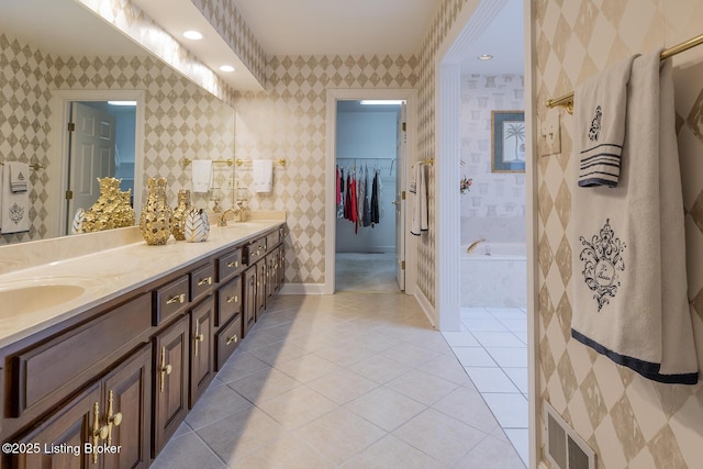7005 New Bern Ct, Prospect, KY 40059 - full bath with double vanity, a garden tub, tile patterned flooring, a spacious closet, and recessed lighting