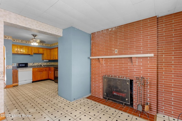 1715 Marlow Rd, Louisville, KY 40216 - kitchen with white dishwasher, black microwave, brown cabinets, a fireplace, and ceiling fan