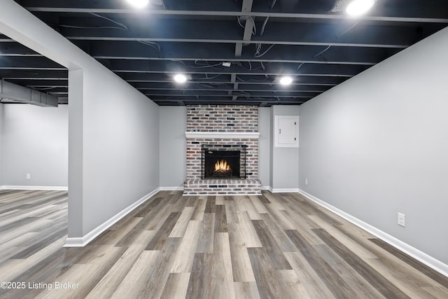 6505 Ridge Cliff Rd, Hollow Creek, KY 40228 - finished basement featuring wood finished floors, a fireplace, and electric panel