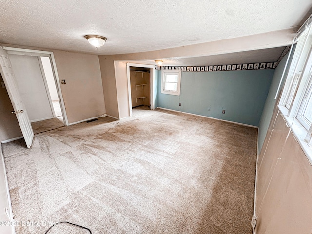 108 Bruce St, Lebanon Junction, KY 40150 - unfurnished bedroom featuring a textured ceiling, light carpet, and a closet