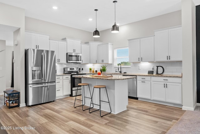 3001 Opal Dr, Shelbyville, KY 40065 - kitchen featuring appliances with stainless steel finishes, white cabinets, light wood-type flooring, backsplash, and recessed lighting