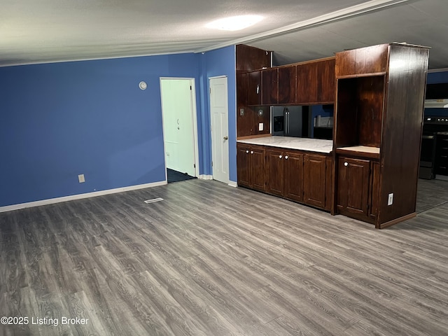 140 Bluegrass Dr, Taylorsville, KY 40071 - kitchen with light countertops, wood finished floors, black fridge with ice dispenser, and dark brown cabinetry