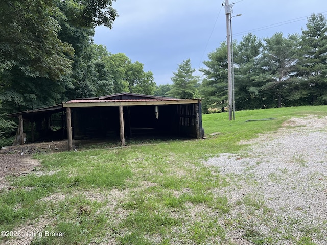140 Bluegrass Dr, Taylorsville, KY 40071 - view of green lawn featuring a pole building, an outbuilding, and a carport