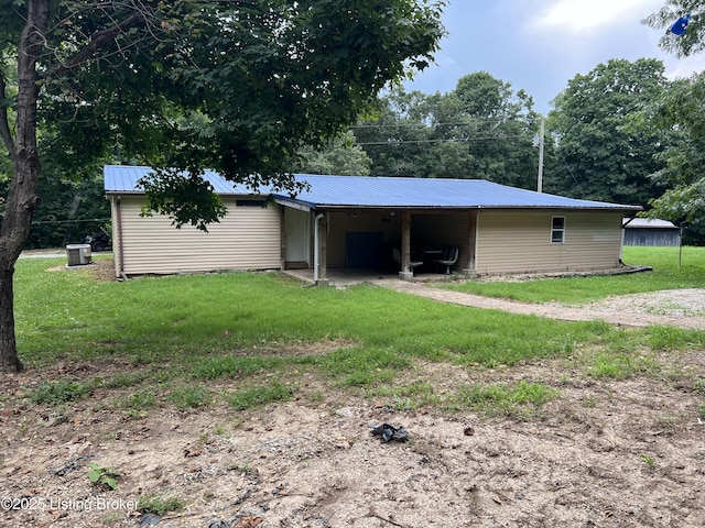 140 Bluegrass Dr, Taylorsville, KY 40071 - rear view of property featuring a metal roof, a yard, and a carport