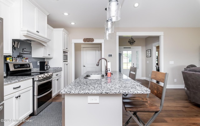 121 Liam Ct, Shepherdsville, KY 40165 - kitchen featuring double oven range, white cabinetry, dark wood finished floors, a kitchen breakfast bar, and recessed lighting