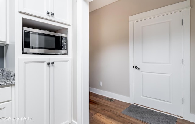 121 Liam Ct, Shepherdsville, KY 40165 - kitchen featuring stainless steel microwave, wood finished floors, white cabinets, and light stone counters