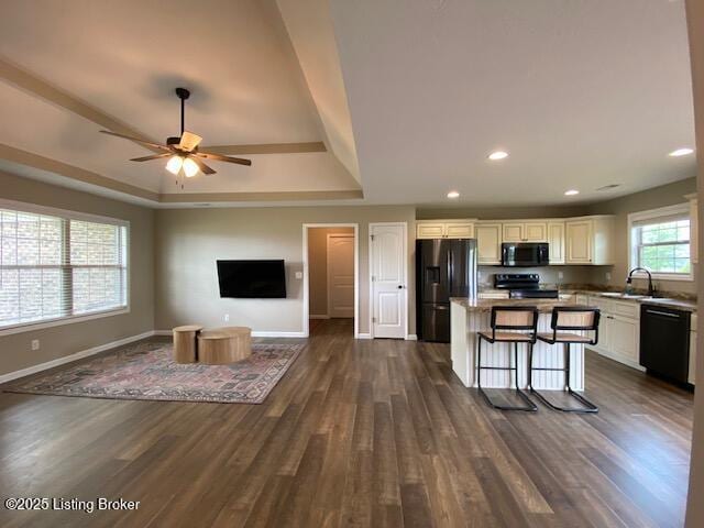 121 Redwood Dr, Bardstown, KY 40004 - kitchen featuring black appliances, a tray ceiling, open floor plan, dark wood-type flooring, and ceiling fan