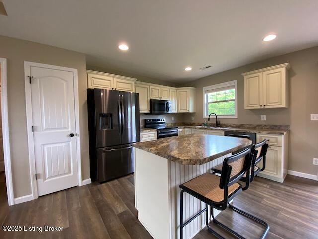 121 Redwood Dr, Bardstown, KY 40004 - kitchen with black appliances, dark wood-style floors, a kitchen island, recessed lighting, and a kitchen breakfast bar