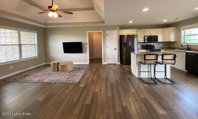 121 Redwood Dr, Bardstown, KY 40004 - kitchen featuring black appliances, a center island, open floor plan, a raised ceiling, and a ceiling fan