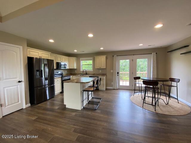 121 Redwood Dr, Bardstown, KY 40004 - kitchen with black appliances, dark wood finished floors, a center island, recessed lighting, and white cabinets