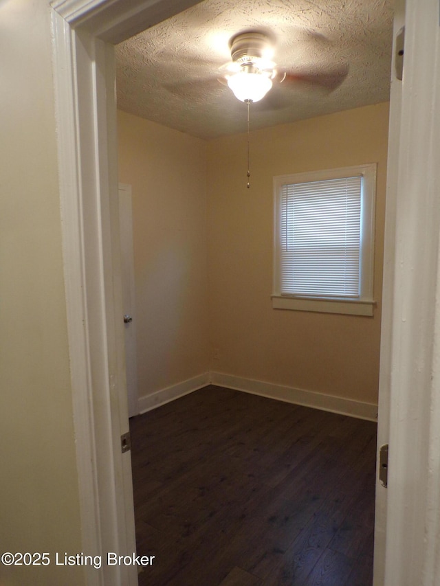 2113 Dumesnil St, Louisville, KY 40210 - empty room featuring a textured ceiling, dark wood-type flooring, and a ceiling fan