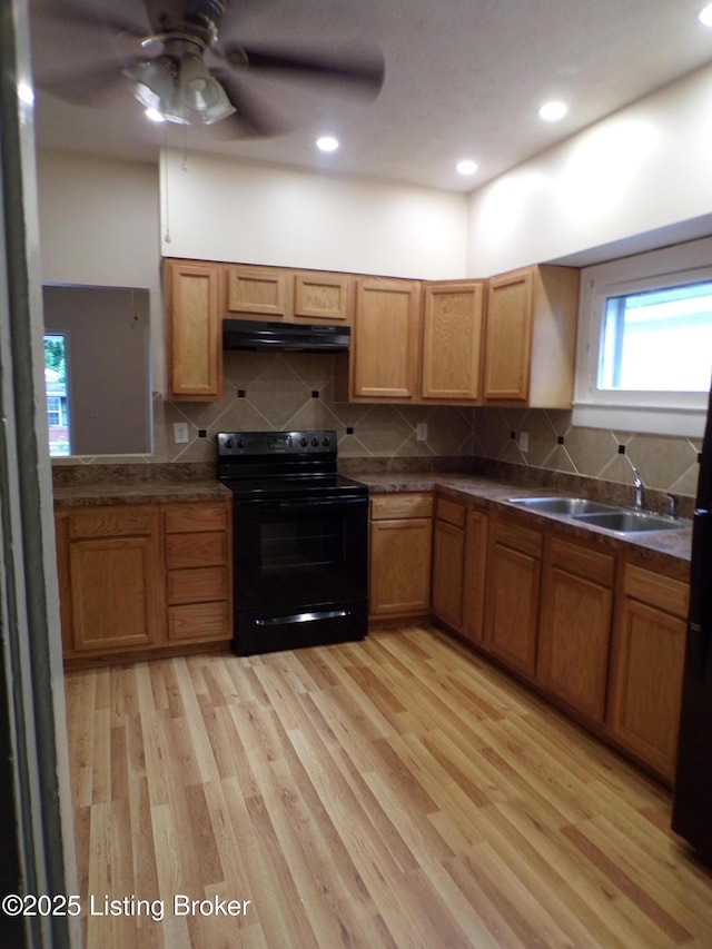 2113 Dumesnil St, Louisville, KY 40210 - kitchen featuring black electric range oven, extractor fan, light wood-style flooring, dark countertops, and recessed lighting