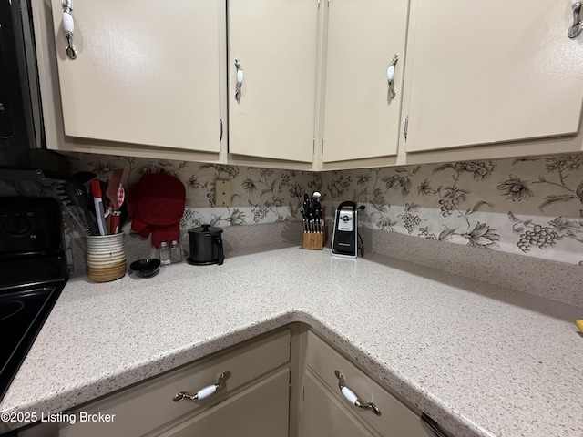 7206 Arrowwood Rd, Louisville, KY 40222 - kitchen with light countertops, range, and white cabinetry