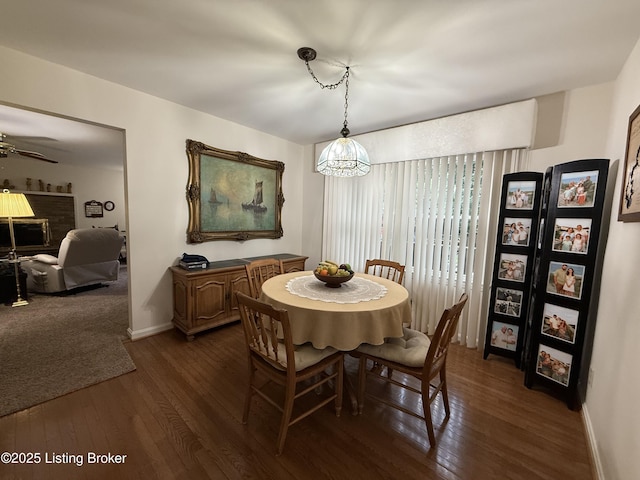 7206 Arrowwood Rd, Louisville, KY 40222 - dining area with dark wood finished floors, ceiling fan, and a brick fireplace
