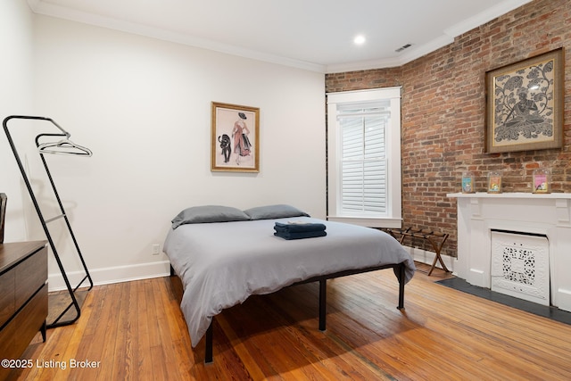 1303 S Floyd St, Louisville, KY 40208 - bedroom featuring light wood-style flooring, ornamental molding, brick wall, and recessed lighting