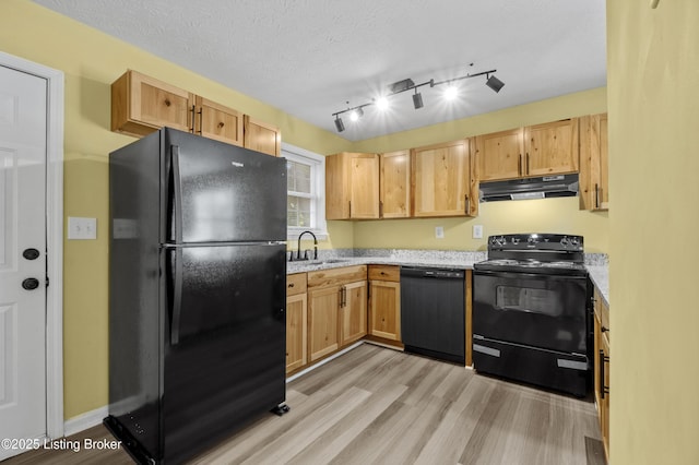 1601 Wilson Ave, Louisville, KY 40210 - kitchen with black appliances, under cabinet range hood, light wood-type flooring, light stone countertops, and light brown cabinets