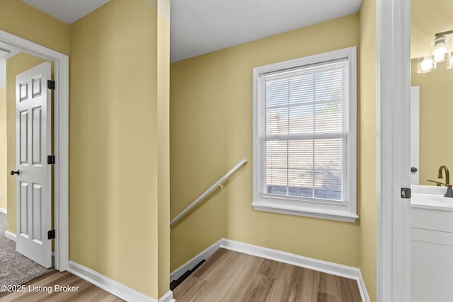 1601 Wilson Ave, Louisville, KY 40210 - corridor with an upstairs landing and wood finished floors