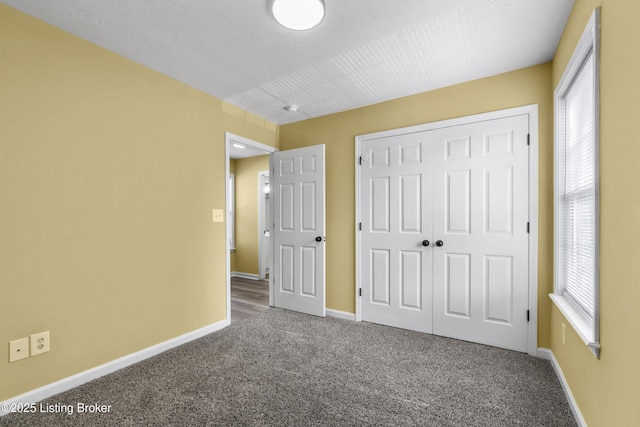 1601 Wilson Ave, Louisville, KY 40210 - unfurnished bedroom with carpet flooring, multiple windows, and a closet