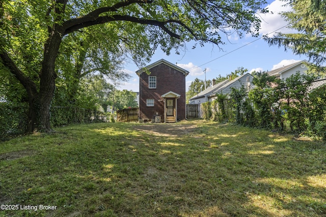 1601 Wilson Ave, Louisville, KY 40210 - back of property featuring a fenced backyard and brick siding