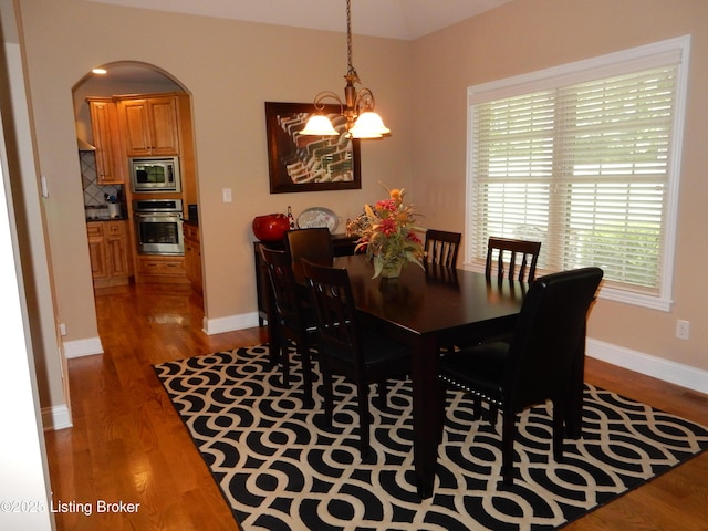 193 Pare Ct, Shepherdsville, KY 40165 - dining room with a chandelier, wood finished floors, and arched walkways