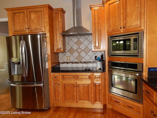 193 Pare Ct, Shepherdsville, KY 40165 - kitchen with appliances with stainless steel finishes, wall chimney range hood, tasteful backsplash, brown cabinetry, and wood finished floors