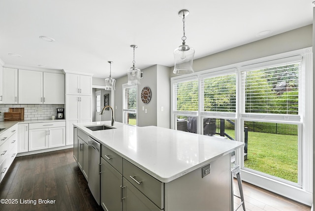 12512 Kirkham Rd, Louisville, KY 40299 - kitchen featuring dishwasher, light countertops, dark wood-style floors, and backsplash