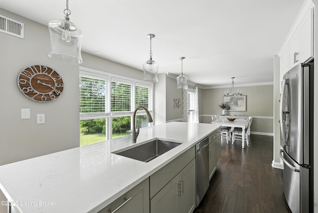 12512 Kirkham Rd, Louisville, KY 40299 - kitchen featuring appliances with stainless steel finishes, dark wood-type flooring, pendant lighting, white cabinets, and light stone countertops