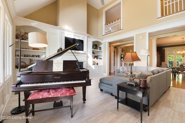 9906 Glen Vista Dr, Prospect, KY 40059 - living room with high vaulted ceiling, decorative columns, a chandelier, built in features, and crown molding