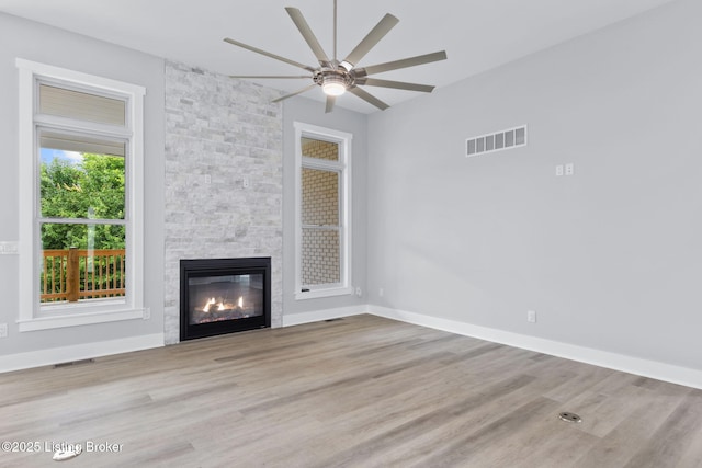 7103 Star Barn Ln, Crestwood, KY 40014 - unfurnished living room featuring a ceiling fan, a stone fireplace, and wood finished floors