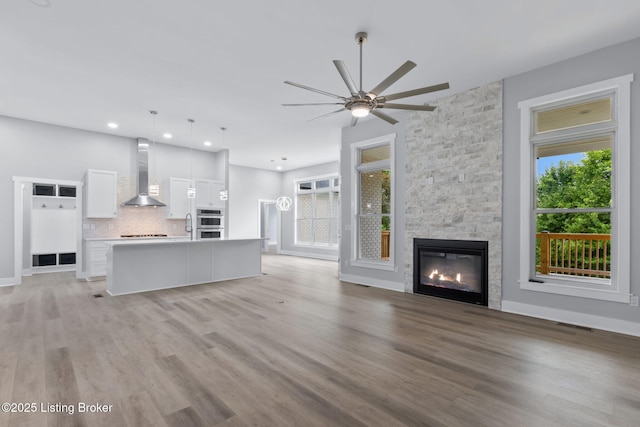 7103 Star Barn Ln, Crestwood, KY 40014 - unfurnished living room featuring healthy amount of natural light, ceiling fan, light wood-style floors, and recessed lighting