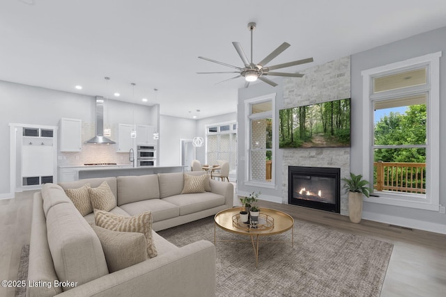 7103 Star Barn Ln, Crestwood, KY 40014 - living room featuring light wood-type flooring, ceiling fan, a large fireplace, and recessed lighting