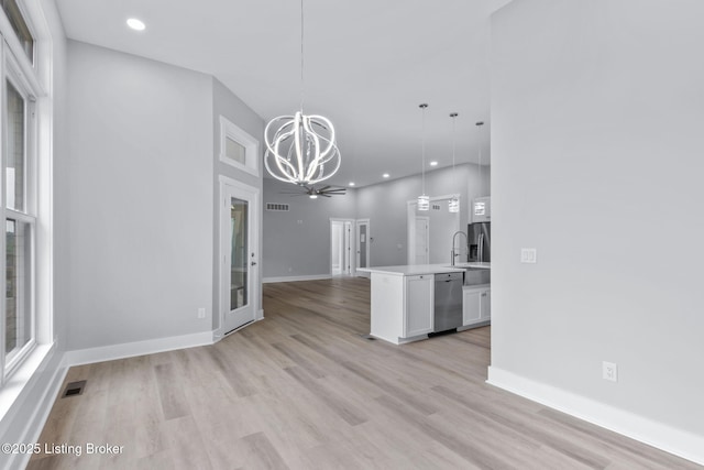 7103 Star Barn Ln, Crestwood, KY 40014 - kitchen with stainless steel dishwasher, open floor plan, a chandelier, light countertops, and white cabinets