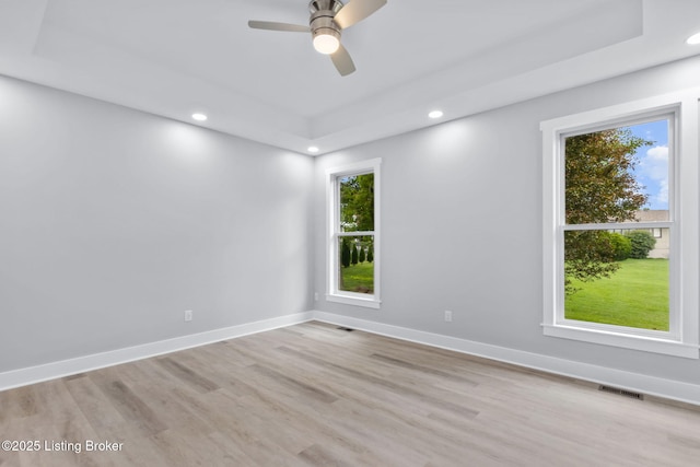 7103 Star Barn Ln, Crestwood, KY 40014 - empty room with healthy amount of natural light, ceiling fan, recessed lighting, wood finished floors, and a raised ceiling