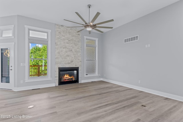 7103 Star Barn Ln, Crestwood, KY 40014 - unfurnished living room featuring a stone fireplace, ceiling fan, and wood finished floors