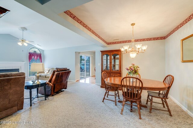 6708 Island Pointe Pl, Louisville, KY 40258 - dining room with healthy amount of natural light, a chandelier, a fireplace, a ceiling fan, and lofted ceiling