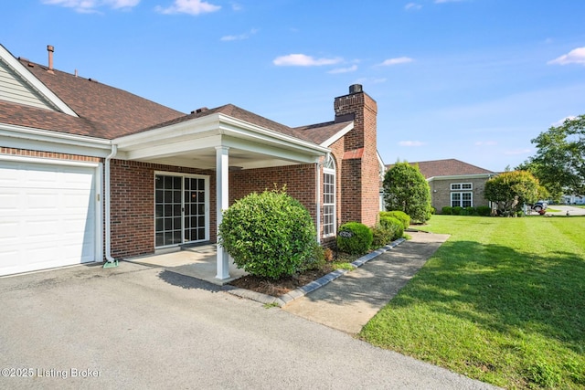 6708 Island Pointe Pl, Louisville, KY 40258 - view of side of home featuring a yard, a chimney, brick siding, and an attached garage