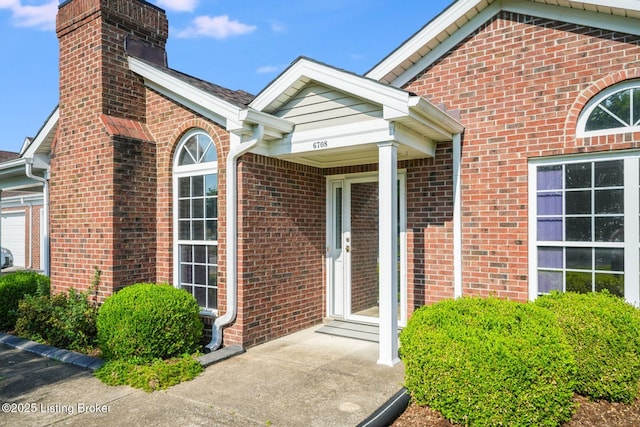 6708 Island Pointe Pl, Louisville, KY 40258 - view of exterior entry featuring brick siding and a chimney