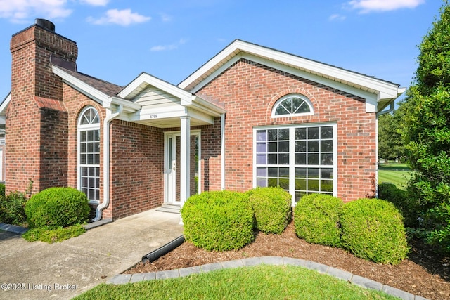 6708 Island Pointe Pl, Louisville, KY 40258 - view of front facade with a chimney and brick siding