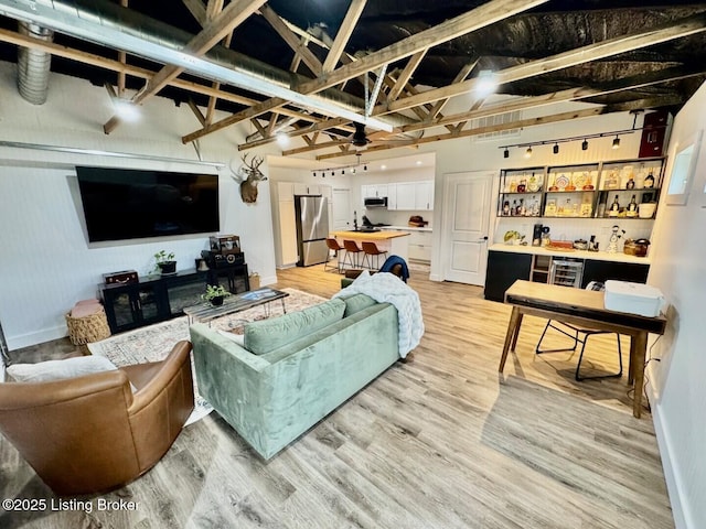 9068 Mackville Rd, Springfield, KY 40069 - living area with light wood-type flooring, ceiling fan, and bar area