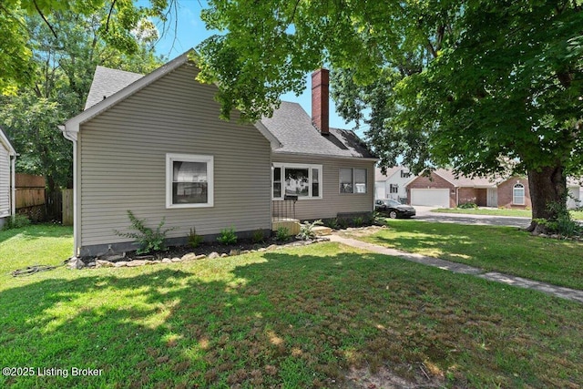 428 Pennsylvania Ave, Elizabethtown, KY 42701 - view of front of house with a chimney, a front lawn, a shingled roof, and a garage