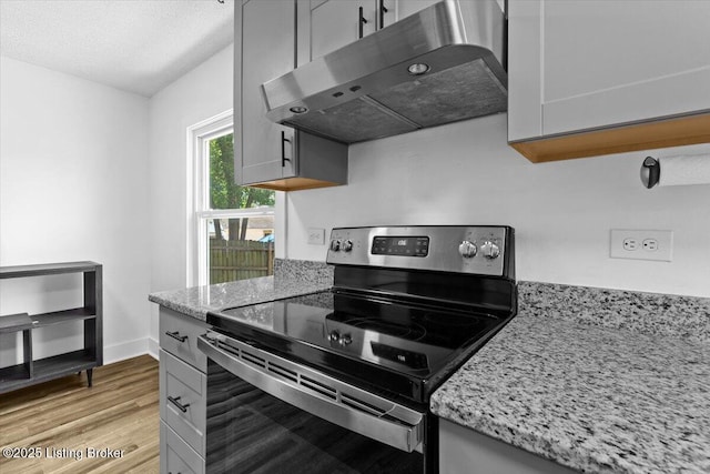 428 Pennsylvania Ave, Elizabethtown, KY 42701 - kitchen featuring electric range, ventilation hood, light wood-style flooring, light stone counters, and a textured ceiling