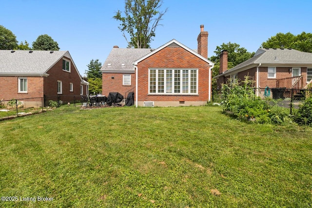 3002 Eagle Pass, Louisville, KY 40217 - back of property featuring brick siding, a chimney, and a fenced backyard