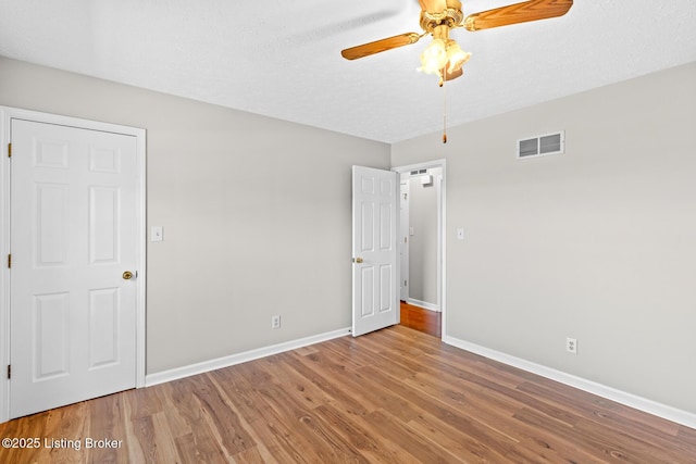 360 Van Buren Rd, Mount Eden, KY 40046 - unfurnished bedroom with wood finished floors, a ceiling fan, and a textured ceiling