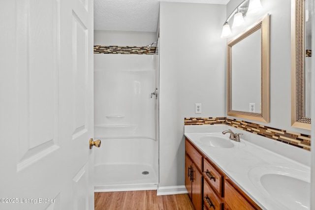 360 Van Buren Rd, Mount Eden, KY 40046 - full bath featuring double vanity, a shower, wood finished floors, decorative backsplash, and a textured ceiling