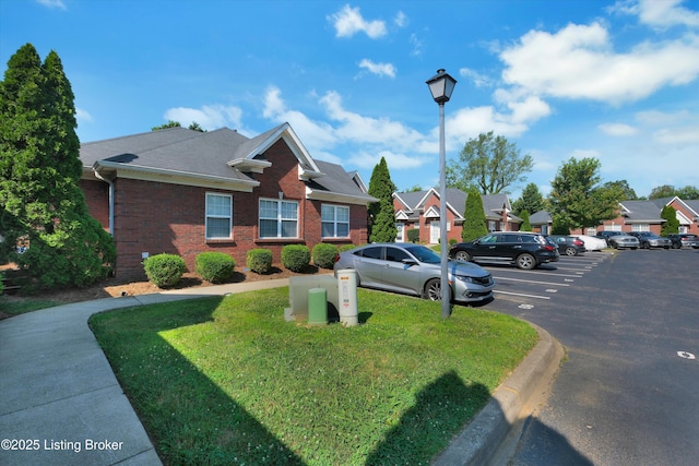 7230 Michael Benjamin Cir, Crestwood, KY 40014 - view of front facade with uncovered parking, brick siding, a front lawn, roof with shingles, and a residential view