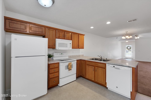 7230 Michael Benjamin Cir, Crestwood, KY 40014 - kitchen featuring white appliances, a peninsula, light countertops, brown cabinetry, and recessed lighting