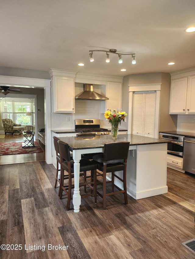 1860 Alfresco Pl, Louisville, KY 40205 - kitchen with wall chimney range hood, stainless steel appliances, white cabinetry, and recessed lighting