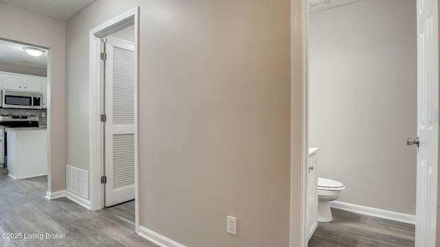 4806 Middlesex Dr, Louisville, KY 40245 - hallway featuring wood finished floors and baseboards